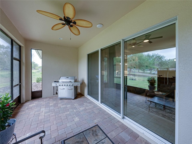 unfurnished sunroom with a ceiling fan