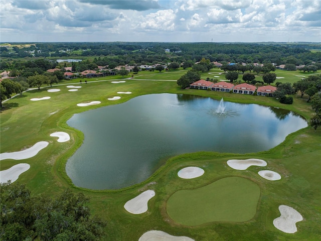 drone / aerial view featuring view of golf course and a water view