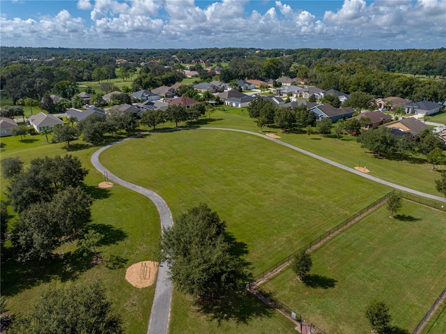 drone / aerial view with a forest view and a residential view