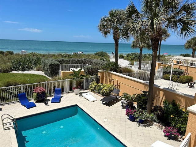 view of swimming pool with fence, a water view, a patio, and a fenced in pool