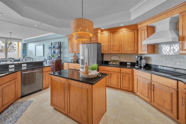 kitchen featuring wall chimney range hood, light tile patterned floors, a tray ceiling, backsplash, and appliances with stainless steel finishes