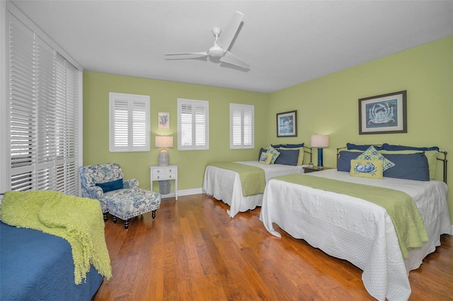 bedroom with baseboards, a ceiling fan, and wood finished floors
