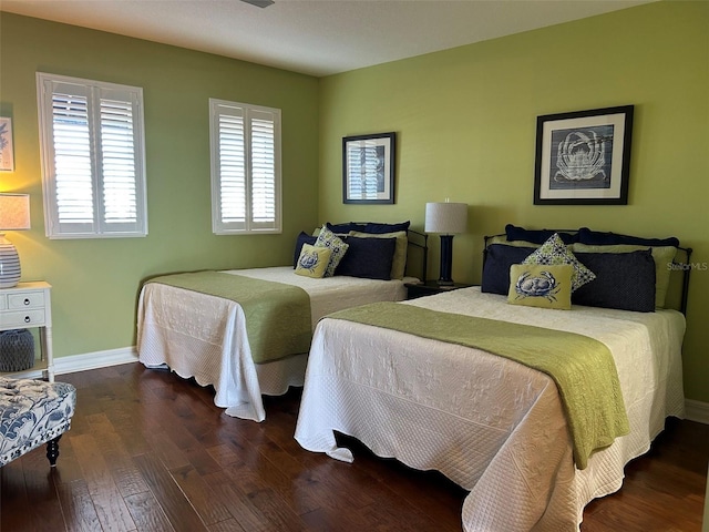 bedroom featuring baseboards and wood finished floors