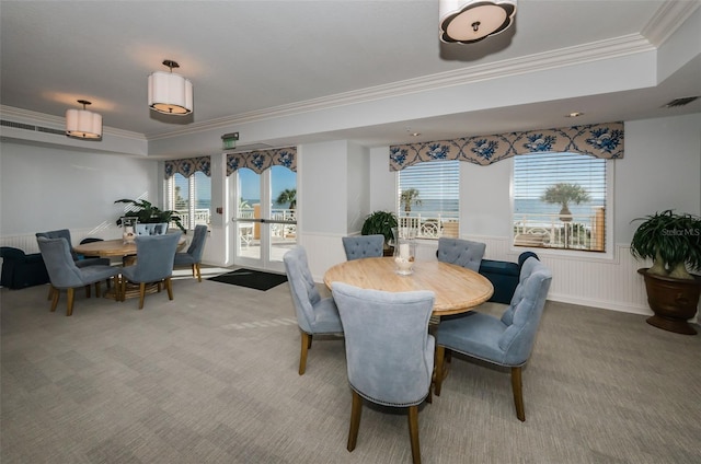 dining room with wainscoting, carpet floors, crown molding, and visible vents