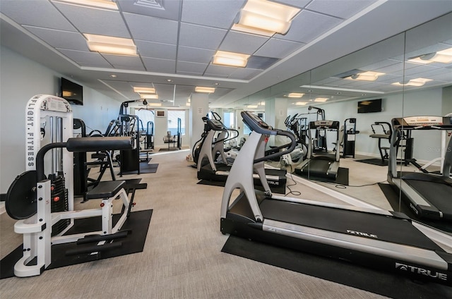 gym with baseboards, carpet flooring, and a drop ceiling