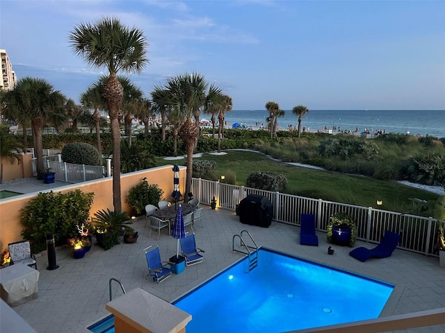 view of swimming pool with a fenced in pool, a patio, a water view, and fence