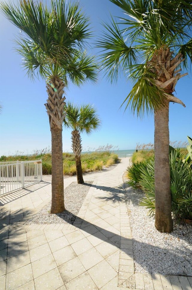 view of property's community with a beach view and a water view
