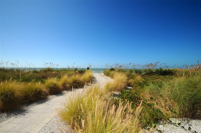 view of street with a beach view and a water view
