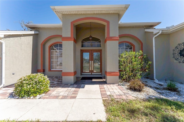 property entrance with french doors and stucco siding