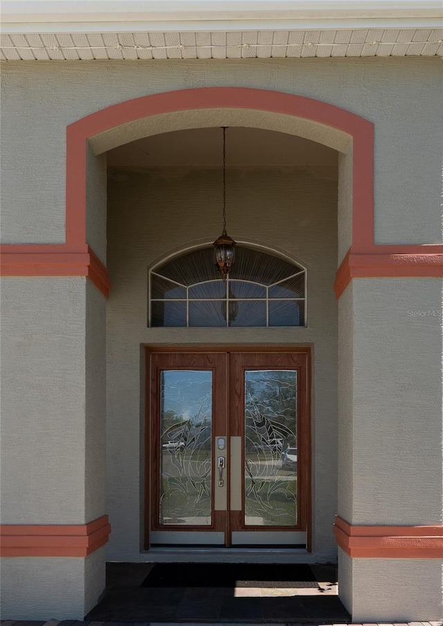doorway to property with french doors and stucco siding