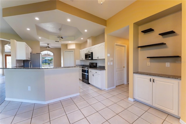 kitchen featuring a tray ceiling, recessed lighting, ceiling fan, white cabinets, and appliances with stainless steel finishes