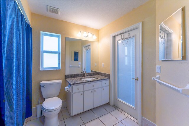 full bath with visible vents, baseboards, toilet, tile patterned floors, and vanity