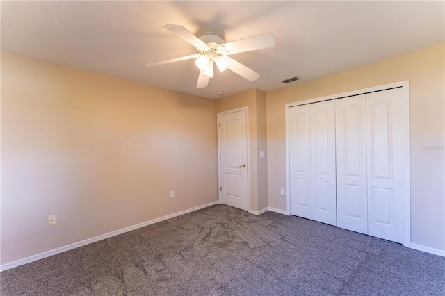 unfurnished bedroom featuring baseboards, carpet flooring, visible vents, and a ceiling fan