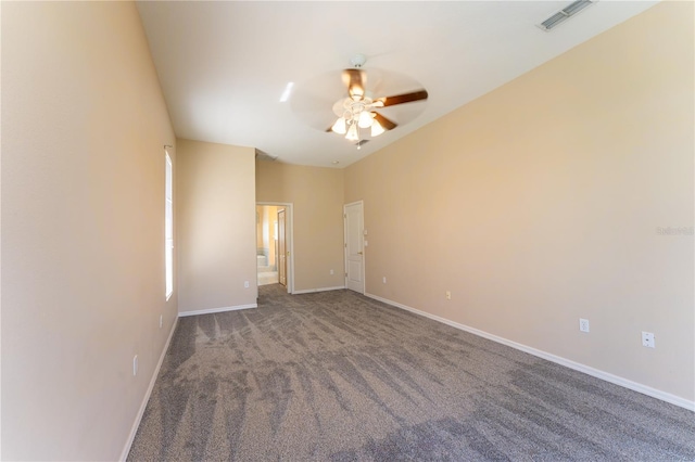 unfurnished room featuring baseboards, ceiling fan, visible vents, and carpet