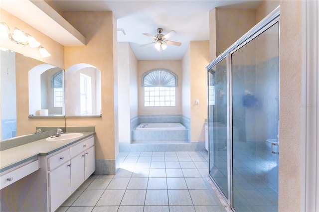 full bathroom featuring a stall shower, tile patterned floors, ceiling fan, and vanity