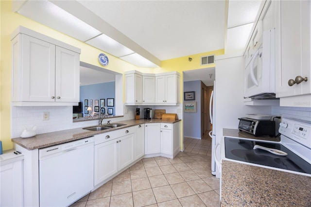 8020 Sailboat Key Blvd S Unit 101, St Pete Beach, FL 33707 - kitchen with white appliances, a sink, decorative backsplash, and white cabinetry