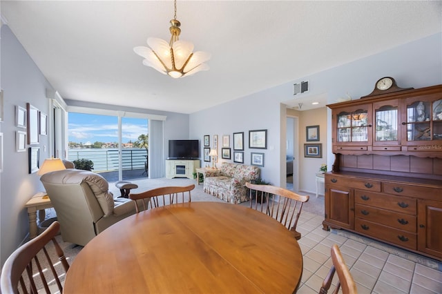 8020 Sailboat Key Blvd S Unit 101, St Pete Beach, FL 33707 - dining room featuring a chandelier and light tile patterned flooring