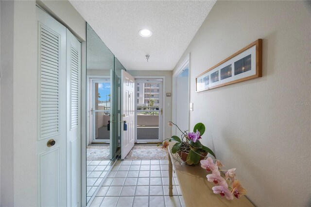 8020 Sailboat Key Blvd S Unit 101, St Pete Beach, FL 33707 - doorway featuring light tile patterned floors, a textured ceiling, and recessed lighting