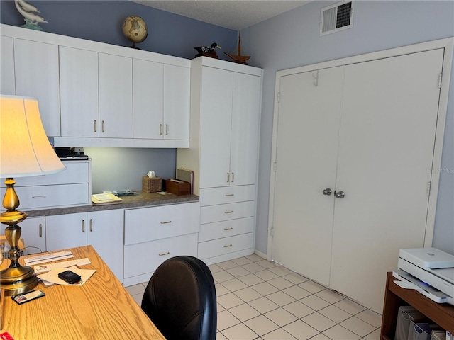 8020 Sailboat Key Blvd S Unit 101, St Pete Beach, FL 33707 - office area featuring light tile patterned floors and a textured ceiling