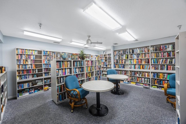 8020 Sailboat Key Blvd S Unit 101, St Pete Beach, FL 33707 - living area with bookshelves and carpet floors
