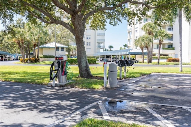 8020 Sailboat Key Blvd S Unit 101, St Pete Beach, FL 33707 - view of property's community featuring a yard and covered and uncovered parking