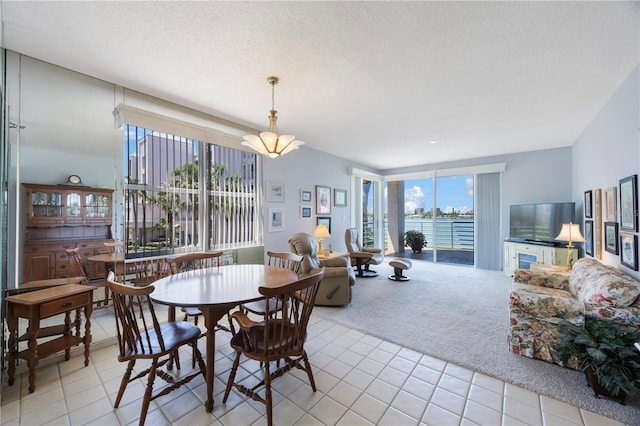 8020 Sailboat Key Blvd S Unit 101, St Pete Beach, FL 33707 - carpeted dining area featuring tile patterned flooring, a chandelier, and a textured ceiling