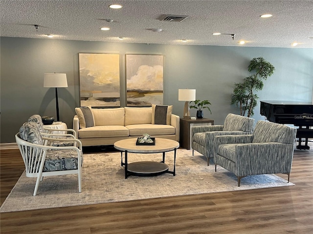 8020 Sailboat Key Blvd S Unit 101, St Pete Beach, FL 33707 - living area with wood finished floors, a textured ceiling, and recessed lighting