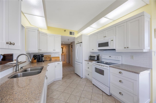 8020 Sailboat Key Blvd S Unit 101, St Pete Beach, FL 33707 - kitchen featuring white appliances, a sink, and white cabinets