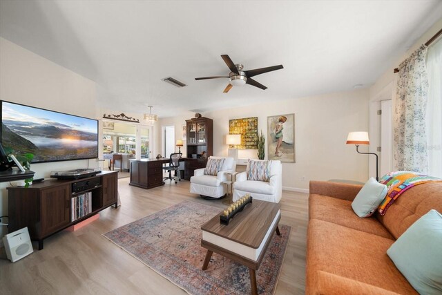 4544 Harbor Hills Dr, Largo, FL 33770 - living area with baseboards, light wood-type flooring, visible vents, and ceiling fan
