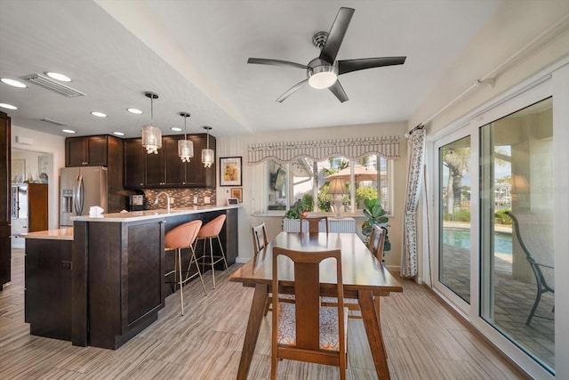 4544 Harbor Hills Dr, Largo, FL 33770 - dining space with light wood finished floors, ceiling fan, and visible vents