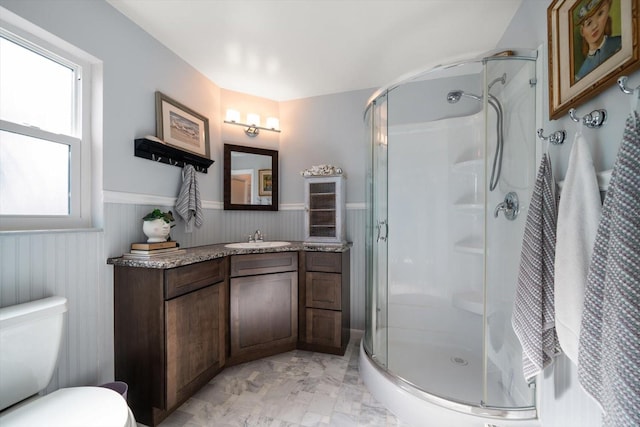 4544 Harbor Hills Dr, Largo, FL 33770 - bathroom with a stall shower, wainscoting, marble finish floor, and vanity