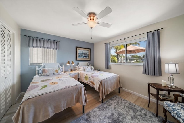 4544 Harbor Hills Dr, Largo, FL 33770 - bedroom featuring a closet, baseboards, wood finished floors, and a ceiling fan