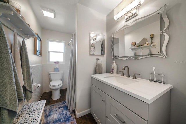 4544 Harbor Hills Dr, Largo, FL 33770 - full bathroom featuring tile walls, wood finished floors, toilet, and vanity
