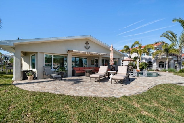 4544 Harbor Hills Dr, Largo, FL 33770 - rear view of house featuring a lawn, an outdoor hangout area, stucco siding, and a patio area