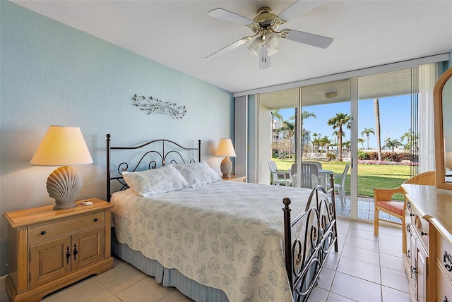6021 Bahia Del Mar Cir Unit 137, Saint Petersburg, FL 33715 - bedroom with floor to ceiling windows, access to exterior, ceiling fan, and light tile patterned floors
