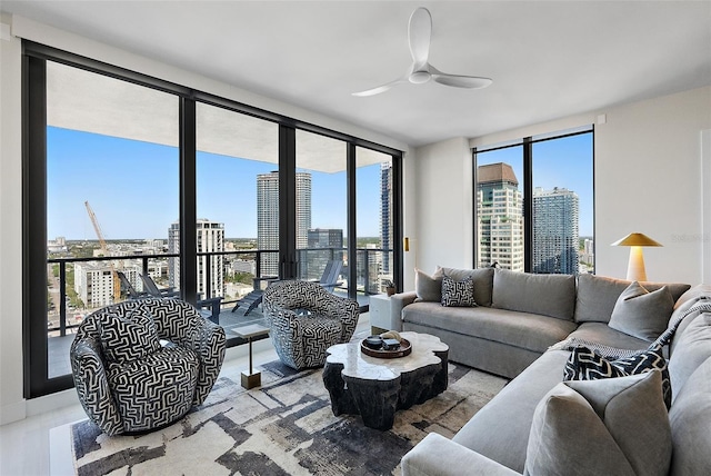 living room with floor to ceiling windows, a view of city, and ceiling fan