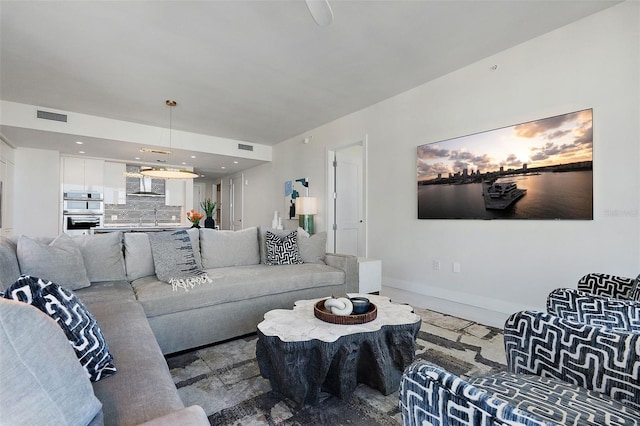 living room with recessed lighting, baseboards, and visible vents