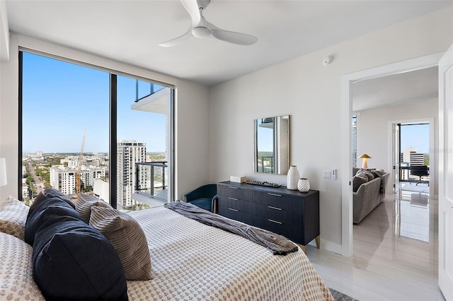 bedroom with a ceiling fan, a wall of windows, access to outside, baseboards, and a view of city