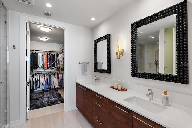 full bath featuring visible vents, a sink, a stall shower, and double vanity