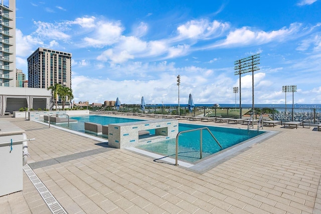 pool with a view of city and a patio