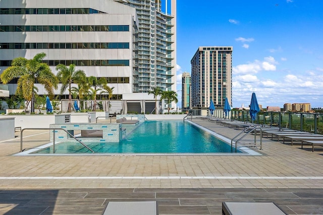pool with a patio and a view of city