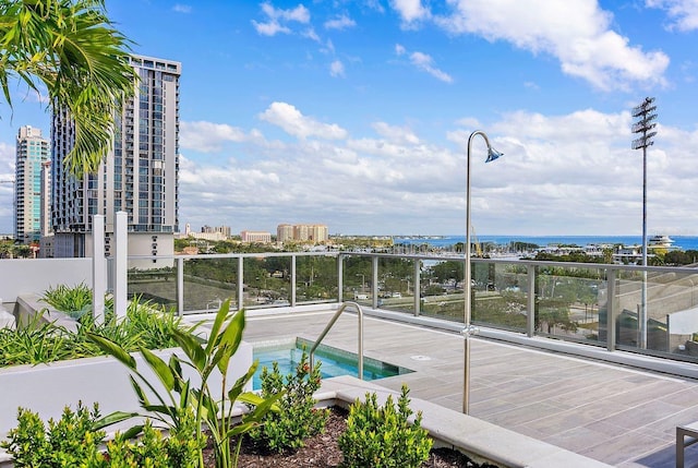 view of swimming pool with a hot tub and a city view