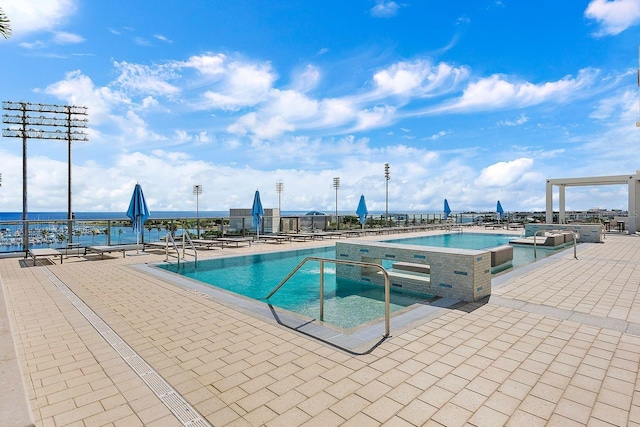 pool with a patio and a jacuzzi