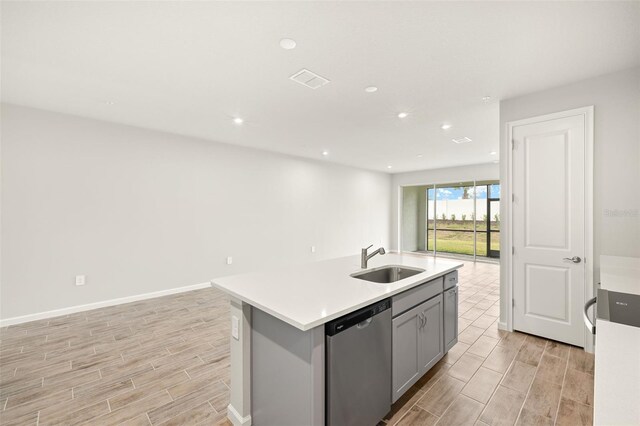 12323 Hearts Ease St, Venice, FL 34293 - kitchen featuring gray cabinets, open floor plan, wood tiled floor, dishwasher, and a sink