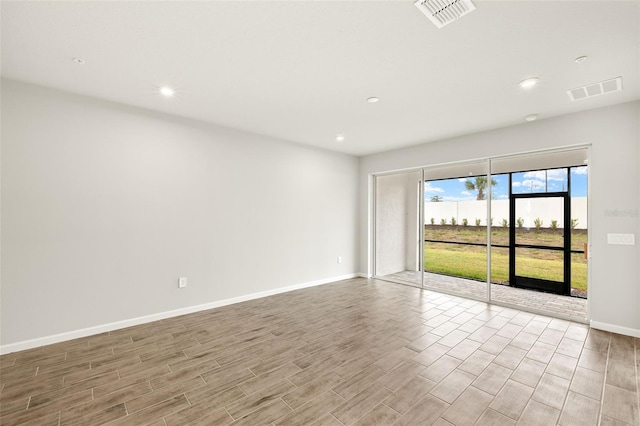 12323 Hearts Ease St, Venice, FL 34293 - spare room with visible vents, baseboards, recessed lighting, and wood finished floors