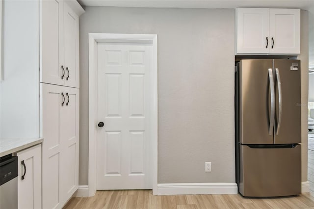 kitchen featuring white cabinets, light wood-style flooring, and stainless steel appliances