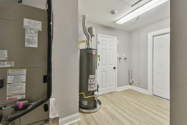 utility room with water heater and heating unit