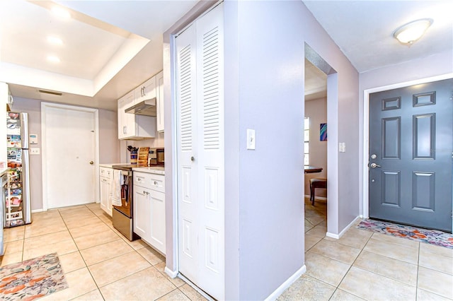 4110 Summerdale Dr, Tampa, FL 33624 - foyer entrance with light tile patterned flooring, visible vents, and baseboards