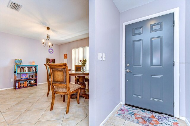 4110 Summerdale Dr, Tampa, FL 33624 - entryway with light tile patterned flooring, baseboards, a chandelier, and visible vents