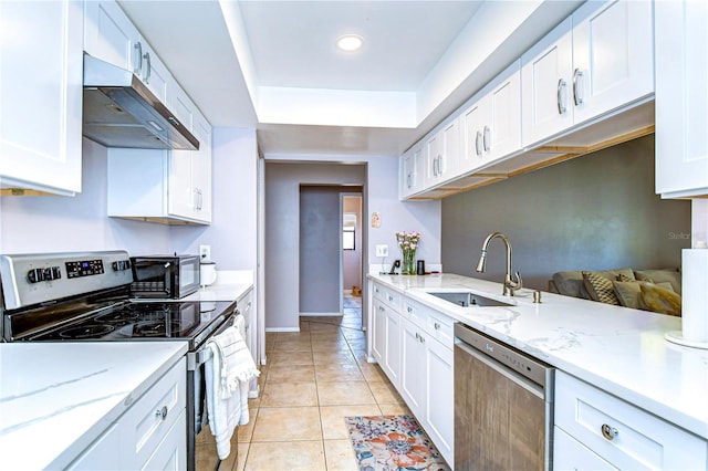 4110 Summerdale Dr, Tampa, FL 33624 - kitchen featuring white cabinetry, a sink, stainless steel appliances, and under cabinet range hood